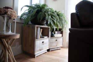 Two small wooden side tables with drawers and storage areas.